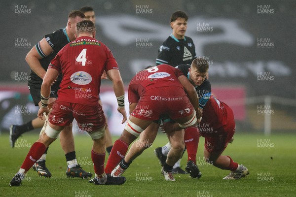 261123 - Ospreys v Scarlets - United Rugby Championship - Keiran Williams of Ospreys is tackled by Carwyn Tuipulotu of Scarlets