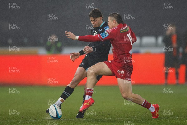 261123 - Ospreys v Scarlets - United Rugby Championship - Jack Walsh of Ospreys kicks the ball under pressure from Steff Evans of Scarlets