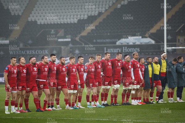261123 - Ospreys v Scarlets - United Rugby Championship - Scarlets players observe a moment of silence for Sam Wainwright's father