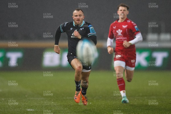 261123 - Ospreys v Scarlets - United Rugby Championship - Luke Morgan of Ospreys and Tom Rogers of Scarlets chase the ball