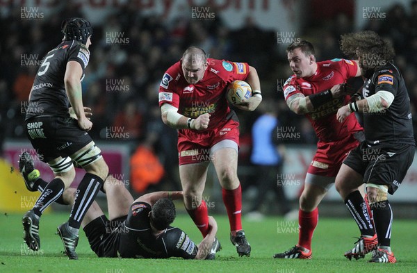 261212 - Ospreys v Scarlets - RaboDirect PRO12 -Phil John of Scarlets is tackled by Ryan Bevington of Ospreys