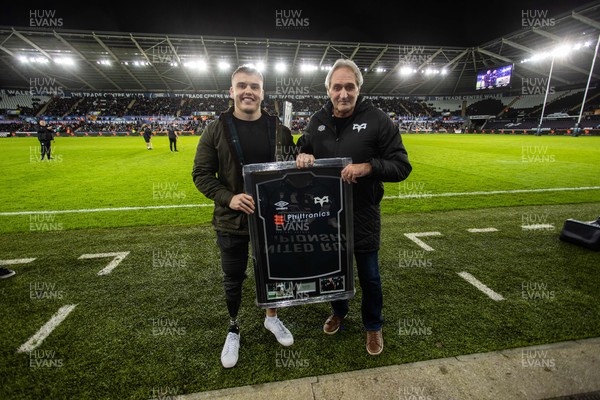 261222 - Ospreys v Scarlets - United Rugby Championship - Roger Blyth presents a shirt to Ifan Phillips