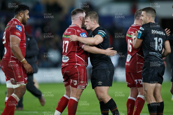 261222 - Ospreys v Scarlets - United Rugby Championship - Jac Morgan of Ospreys and Steff Thomas of Scarlets at the end of the match