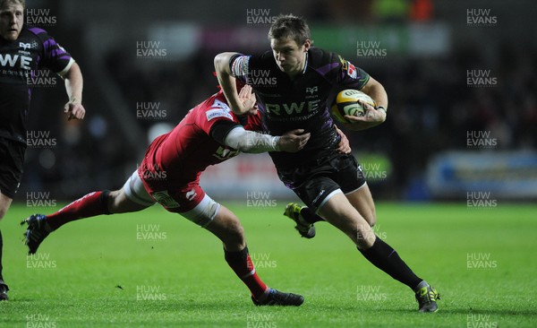 27.12.10 - Ospreys v Scarlets - Magners League - Dan Biggar of Ospreys takes on Gareth Maule of Scarlets. 