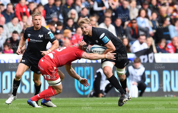 300422 - Ospreys v Scarlets - United Rugby Championship - Will Griffiths of Ospreys is tackled by Joe Roberts of Scarlets