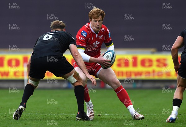 300422 - Ospreys v Scarlets - United Rugby Championship - Rhys Patchell of Scarlets is tackled by Will Griffiths of Ospreys