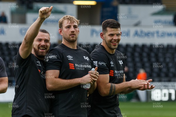 300422 - Ospreys v Scarlets - United Rugby Championship - Morgan Morris, Will Griffiths and Rhys Davies of Ospreys celebrate at the end of the match