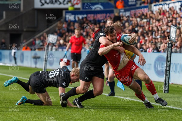 300422 - Ospreys v Scarlets - United Rugby Championship - Ryan Conbeer of Scarlets is tackled