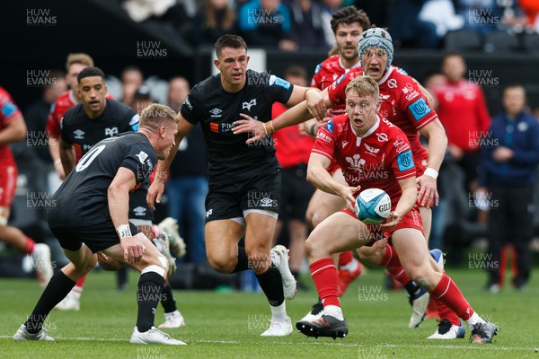 300422 - Ospreys v Scarlets - United Rugby Championship - Sam Costelow of Scarlets passes the ball