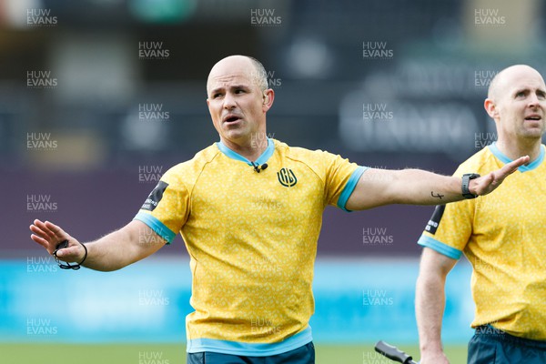 300422 - Ospreys v Scarlets - United Rugby Championship - Referee Jaco Peyper reviews a decision with the TMO