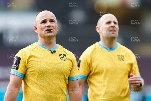 300422 - Ospreys v Scarlets - United Rugby Championship - Referee Jaco Peyper (left) reviews a decision with the TMO