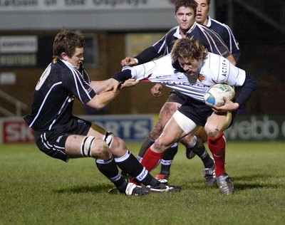 160104Neath Swansea Ospreys v Toulouse  Ospreys James Bater hauls down Cedric Heymans  