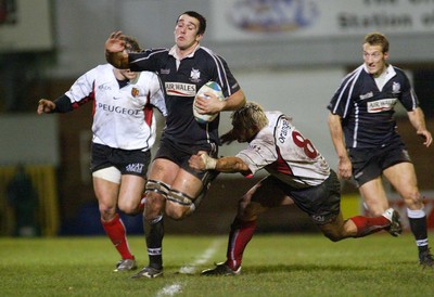 160104Neath Swansea Ospreys v Toulouse  Ospreys Jonathan Thomas breaks away from Christian Labit  