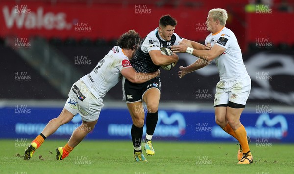 080918 - Ospreys v Toyota Cheetahs - Guinness PRO14 - Owen Watkin of Ospreys is tackled by Nico Lee and Tian Schoeman of Cheetahs
