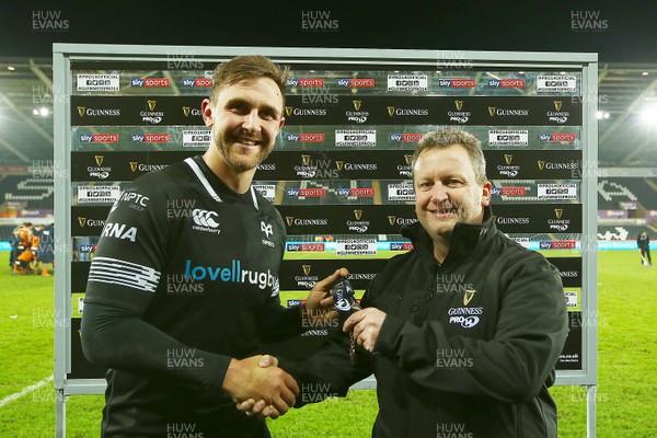 240218 - Ospreys v Toyota Cheetahs - GuinnessPro14 - Ashley Beck of Ospreys receives the man of the match award from Rob Elias representing Guinness