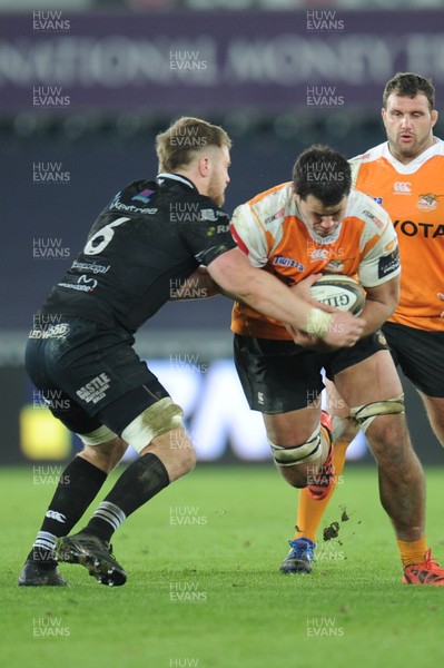 240218 - Ospreys v Toyota Cheetahs - Guinness PRO14 -  Justin Basson of Toyota Cheetahs is tackled by Olly Cracknell of Ospreys