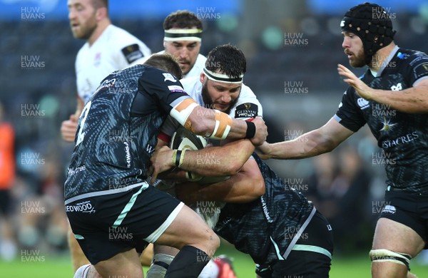 101020 - Ospreys v Ulster - Guinness PRO14 - Marcell Coetzee of Ulster is tackled by Sam Parry and Tom Botha of Ospreys