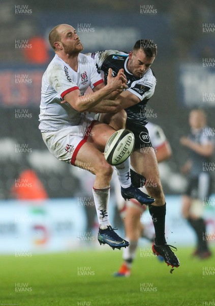150220 - Ospreys v Ulster Rugby, Guinness PRO14 - Matt Faddes of Ulster and Cai Evans of Ospreys compete for the ball