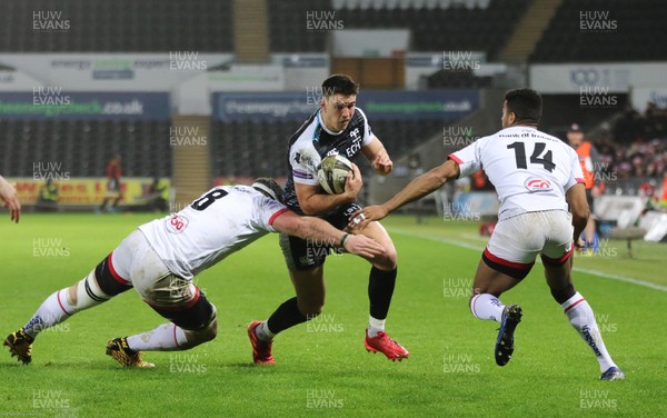 150220 - Ospreys v Ulster Rugby, Guinness PRO14 - Owen Watkin of Ospreys is tackled by Marcell Coetzee of Ulster and Robert Baloucoune of Ulster