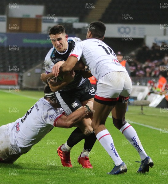 150220 - Ospreys v Ulster Rugby, Guinness PRO14 - Owen Watkin of Ospreys is tackled by Marcell Coetzee of Ulster and Robert Baloucoune of Ulster