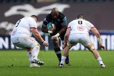 180224 - Ospreys v Ulster - United Rugby Championship - Victor Sekekete of Ospreys is tackled by Marty Moore and Nick Timoney of Ulster 