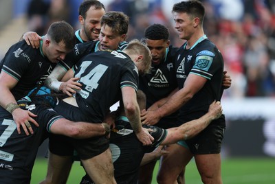 180224 - Ospreys v Ulster, United Rugby Championship - Keiran Williams of Ospreys is congratulated by team mates after scoring try