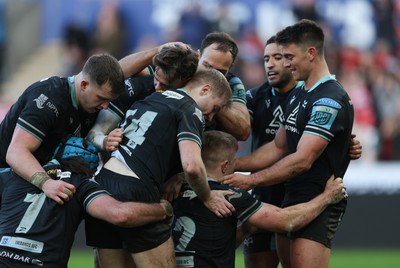 180224 - Ospreys v Ulster, United Rugby Championship - Keiran Williams of Ospreys is congratulated by team mates after scoring try