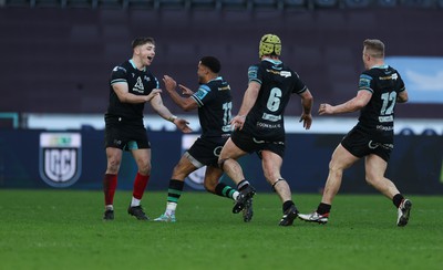 180224 - Ospreys v Ulster, United Rugby Championship - Dan Edwards of Ospreys celebrates with Keelan Giles, Harri Deaves and Keiran Williams after he scores a last minute drop goal