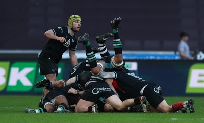 180224 - Ospreys v Ulster, United Rugby Championship - Team mates pile on and celebrate with Dan Edwards of Ospreys after he scores a last minute drop goal