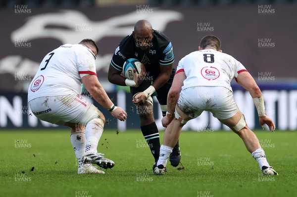 180224 - Ospreys v Ulster - United Rugby Championship - Victor Sekekete of Ospreys is tackled by Marty Moore and Nick Timoney of Ulster 