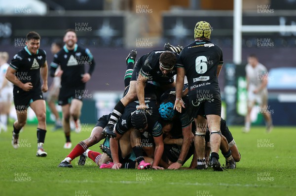 180224 - Ospreys v Ulster - United Rugby Championship - Dan Edwards of Ospreys is piled on in the celebration after kicking a drop goal in the last seconds of the game to win the match