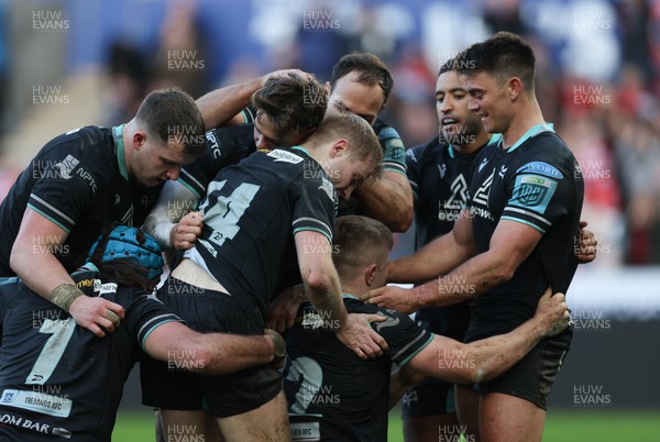 180224 - Ospreys v Ulster, United Rugby Championship - Keiran Williams of Ospreys is congratulated by team mates after scoring try