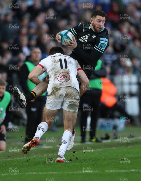180224 - Ospreys v Ulster, United Rugby Championship - Alex Cuthbert of Ospreys is tackled by Jacob Stockdale of Ulster