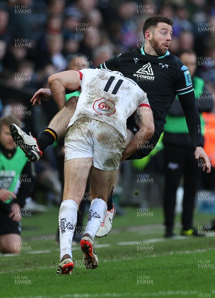 180224 - Ospreys v Ulster, United Rugby Championship - Alex Cuthbert of Ospreys is tackled by Jacob Stockdale of Ulster