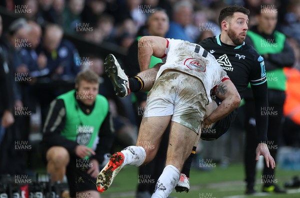 180224 - Ospreys v Ulster, United Rugby Championship - Alex Cuthbert of Ospreys is tackled by Jacob Stockdale of Ulster