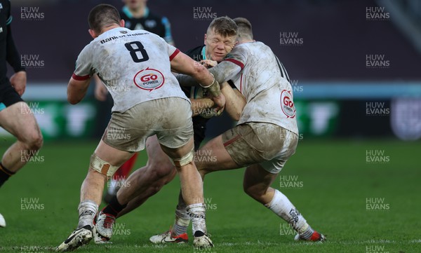 180224 - Ospreys v Ulster, United Rugby Championship - Keiran Williams of Ospreys takes on Jake Flannery of Ulster and Nick Timoney of Ulster