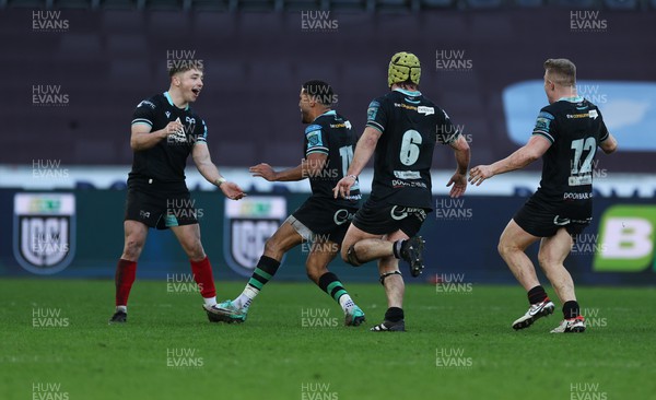 180224 - Ospreys v Ulster, United Rugby Championship - Dan Edwards of Ospreys celebrates with Keelan Giles, Harri Deaves and Keiran Williams after he scores a last minute drop goal