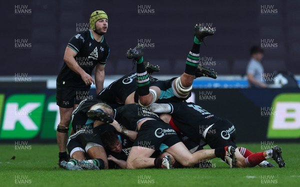 180224 - Ospreys v Ulster, United Rugby Championship - Team mates pile on and celebrate with Dan Edwards of Ospreys after he scores a last minute drop goal