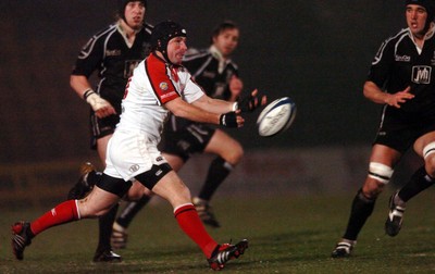 211005 - Ospreys v Ulster - Celtic League - Ulster's  David Humphries gets ball away as Jonathan Thomas closes in (rt)