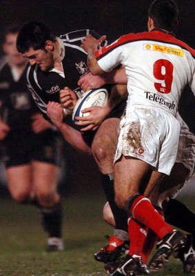 211005 - Ospreys v Ulster - Celtic League - Ospreys' Andy Lloyd is caught by Simon Best and Kieran Campbell