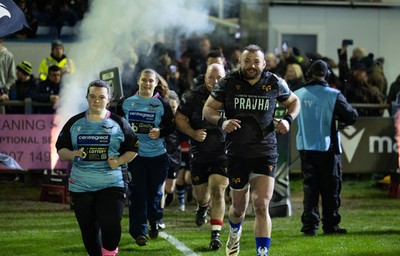 280226 - Ospreys v Ulster Rugby, United Rugby Championship - Sam Parry of Ospreys leads the team out with the mascots at the start of the match