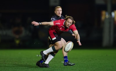 280226 - Ospreys v Ulster Rugby, United Rugby Championship - Werner Kok of Ulster realises there ball as Iestyn Hopkins of Ospreys closes in