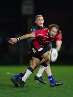 280226 - Ospreys v Ulster Rugby, United Rugby Championship - Werner Kok of Ulster realises there ball as Iestyn Hopkins of Ospreys closes in