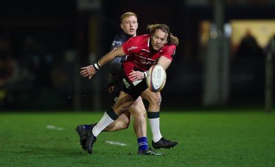 280226 - Ospreys v Ulster Rugby, United Rugby Championship - Werner Kok of Ulster realises there ball as Iestyn Hopkins of Ospreys closes in