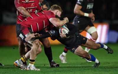 280226 - Ospreys v Ulster Rugby, United Rugby Championship - Jack Walsh of Ospreys is tackled by Bryn Ward of Ulster