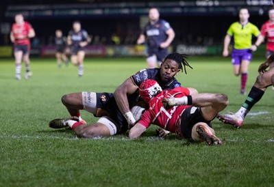 280226 - Ospreys v Ulster Rugby, United Rugby Championship - Dan Kasende of Ospreys robs Michael Lowry of Ulster of the ball and touches down to score try