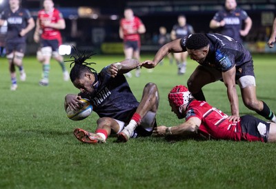 280226 - Ospreys v Ulster Rugby, United Rugby Championship - Dan Kasende of Ospreys robs Michael Lowry of Ulster of the ball and touches down to score try