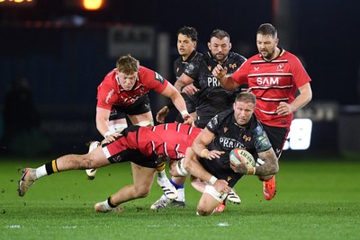 280226 - Ospreys v Ulster - United Rugby Championship - Ross Moriarty of Ospreys is challenged by Tom Stewart of Ulster