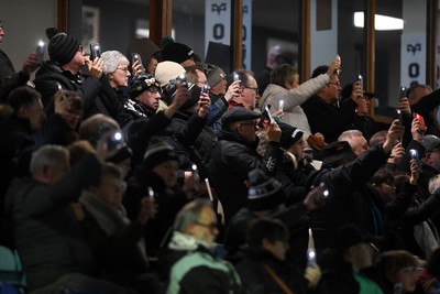 280226 - Ospreys v Ulster - United Rugby Championship - Fans shine their phone lights in protest in the 11th minute after the recent decision made regarding Ospreys by the WRU