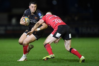 280226 - Ospreys v Ulster - United Rugby Championship - Owen Watkin of Ospreys is challenged by Nathan Doak of Ulster